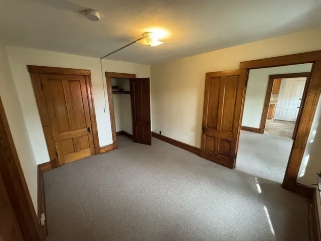 a view of hallway with furniture and a window