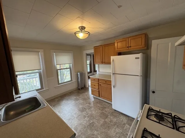 a kitchen with a stove a sink and a refrigerator