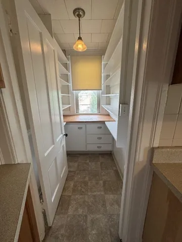 a view of room with window and wooden floor