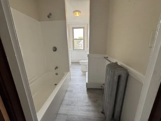 a bathroom with a sink a toilet and window