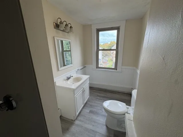 a white toilet sitting next to a white sink