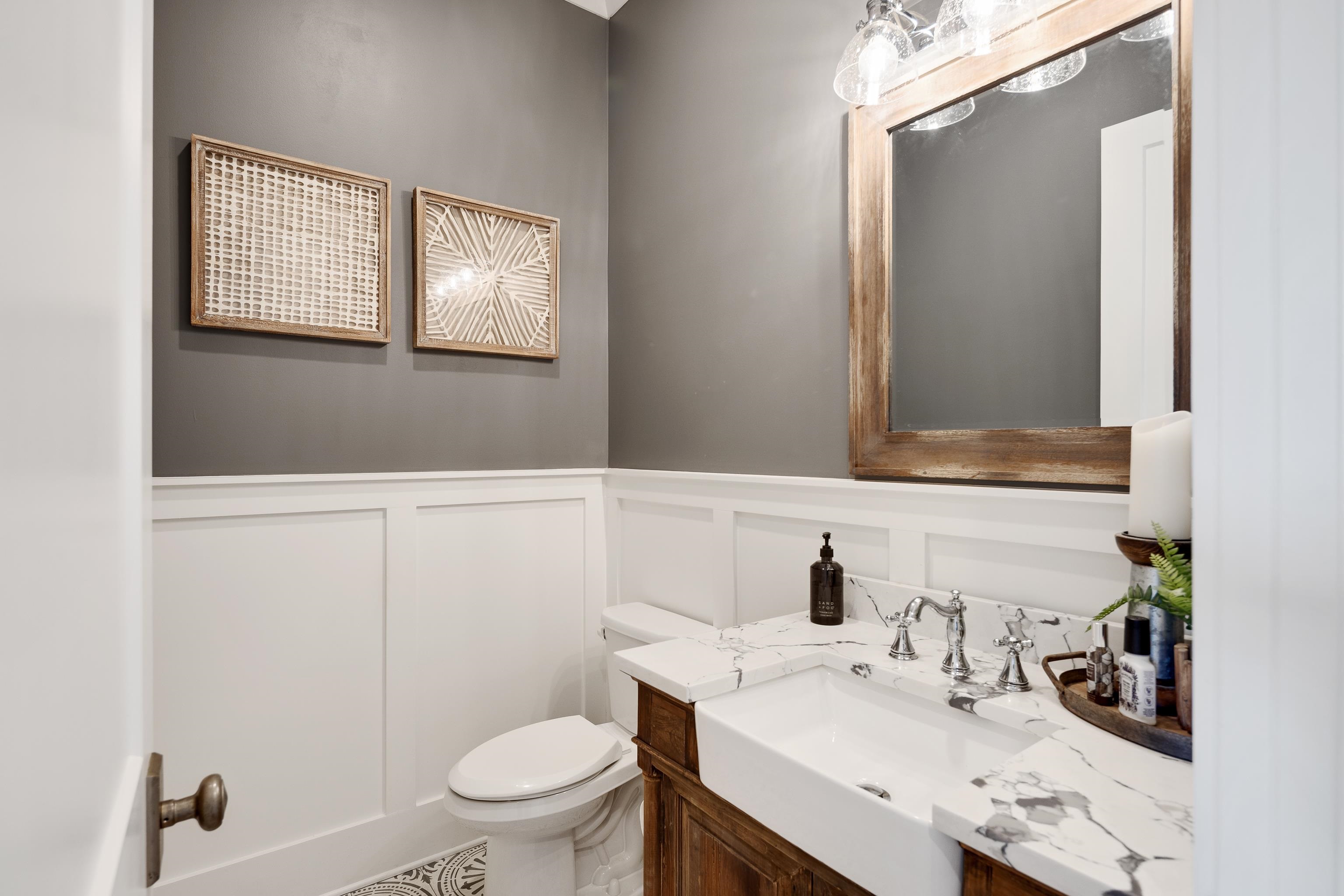 805 Shady Grove Road Williston, TN 38076 - Photo 25 of 40 Bathroom featuring wainscoting, wood-finish vanity, farmhouse sink, and a framed mirror with an overhead light fixture