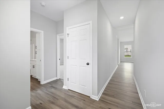 a view of kitchen with refrigerator microwave and stove with wooden floor