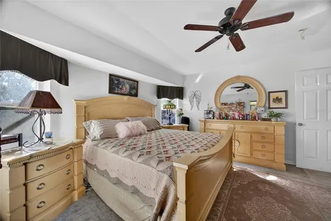 a bedroom with a bed dresser and a window