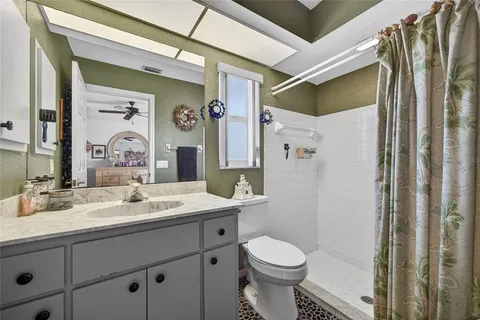 a bathroom with a sink a toilet and shower
