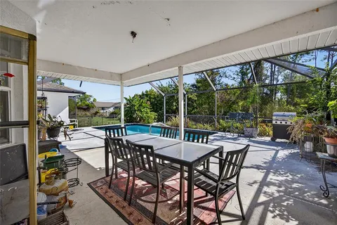 a view of a patio with a table and chairs under an umbrella