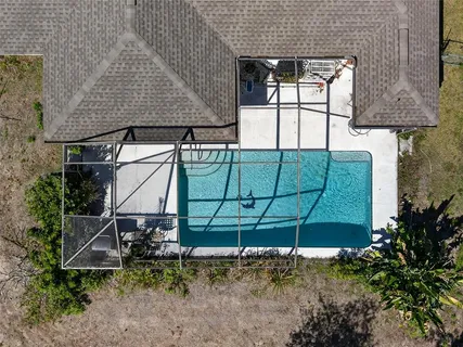 an aerial view of a house with a yard