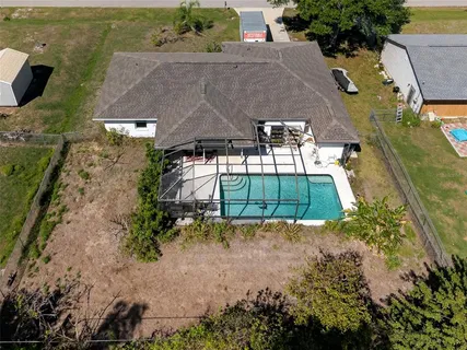 an aerial view of a house with a yard