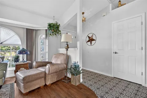 a living room with furniture and a potted plant