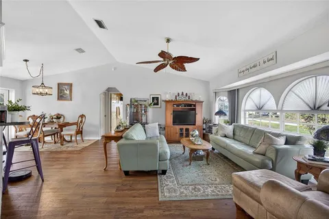 a living room with furniture or couch and a ceiling fan