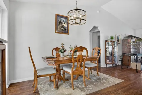 a view of a dining room with furniture wooden floor and chandelier