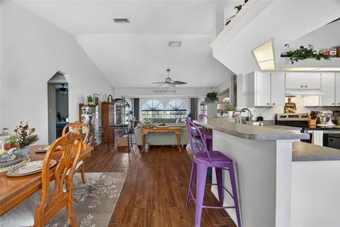 a living room with lots of furniture and kitchen view