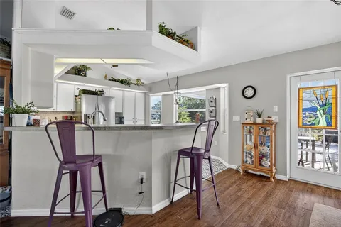 a view of a dining room with furniture and a window