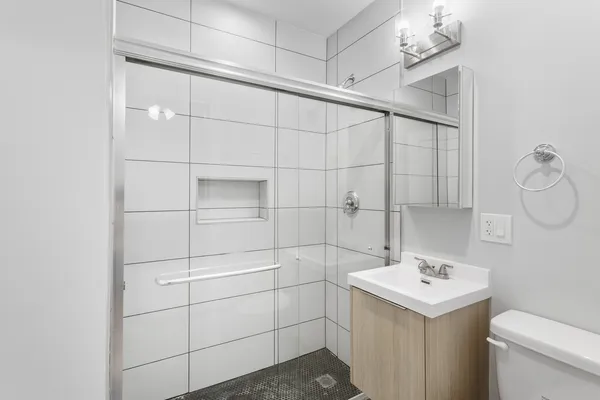 a bathroom with a sink toilet and shower