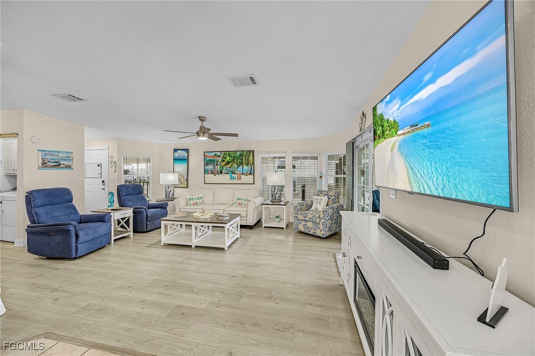 2991 Sloop Lane St. James City, FL 33956 - Photo 11 of 43 a living room with furniture and a flat screen tv