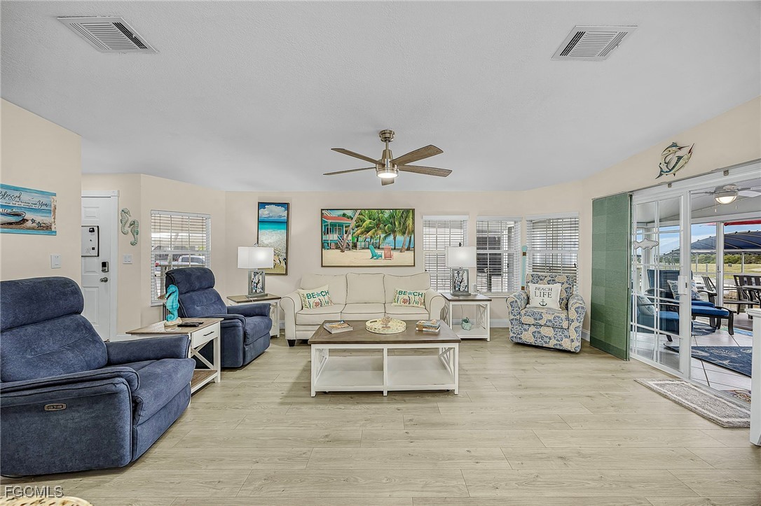 2991 Sloop Lane St. James City, FL 33956 - Photo 15 of 43 a living room with furniture kitchen view and a large window