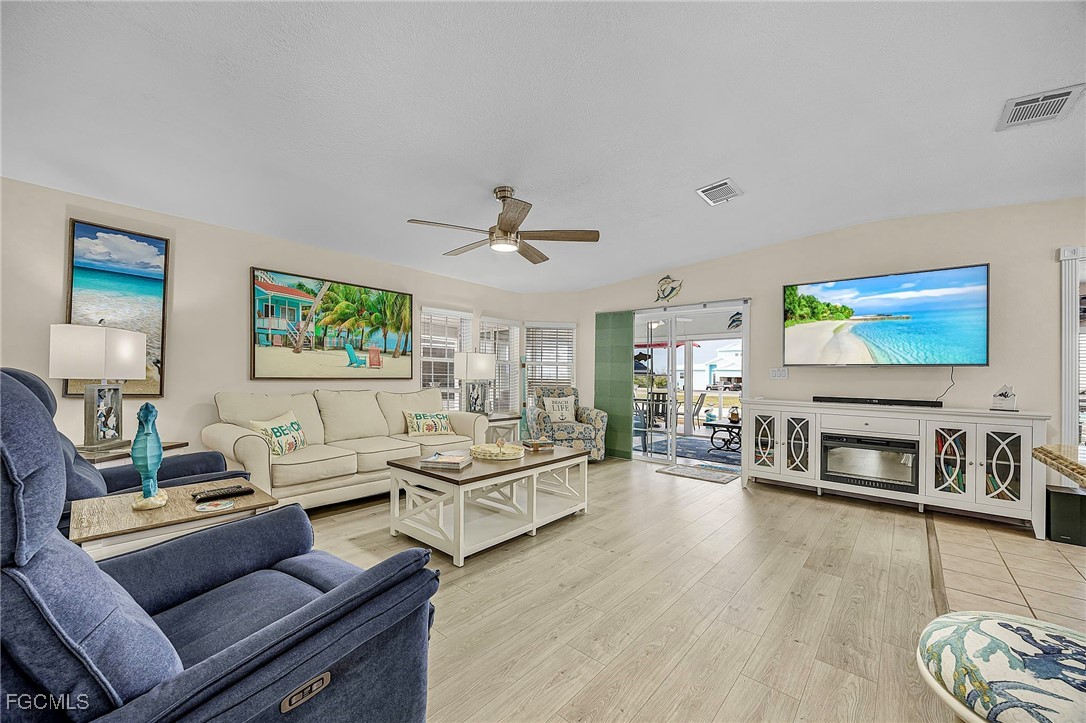 2991 Sloop Lane St. James City, FL 33956 - Photo 19 of 43 a living room with furniture and a flat screen tv