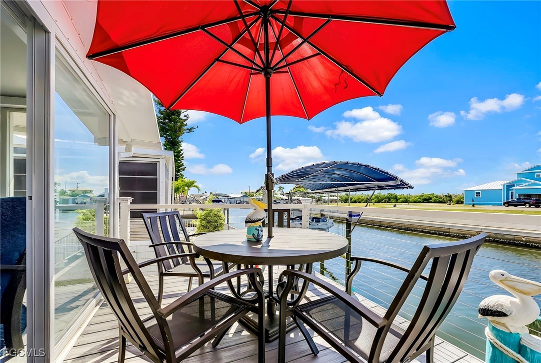 2991 Sloop Lane St. James City, FL 33956 - Photo 20 of 43 a view of an outdoor space with furniture and umbrella