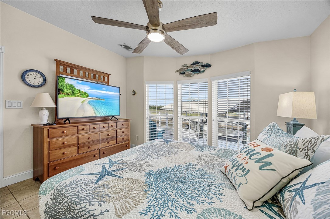 2991 Sloop Lane St. James City, FL 33956 - Photo 28 of 43 a bedroom with a bed and a flat screen tv