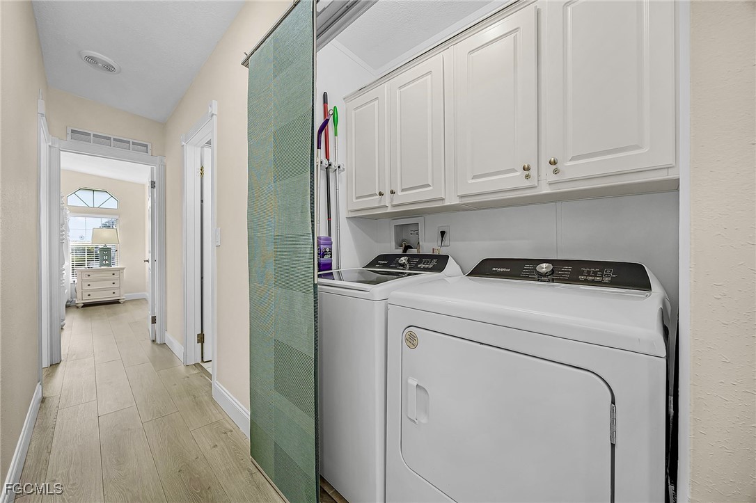 2991 Sloop Lane St. James City, FL 33956 - Photo 31 of 43 a view of washer and dryer with bathroom in the background
