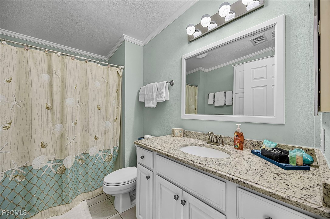 2991 Sloop Lane St. James City, FL 33956 - Photo 33 of 43 a bathroom with a granite countertop sink mirror vanity and toilet