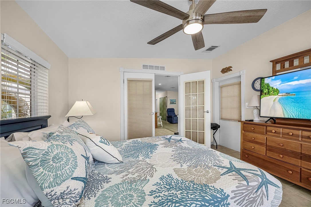 2991 Sloop Lane St. James City, FL 33956 - Photo 35 of 43 a bedroom with a large bed and a window