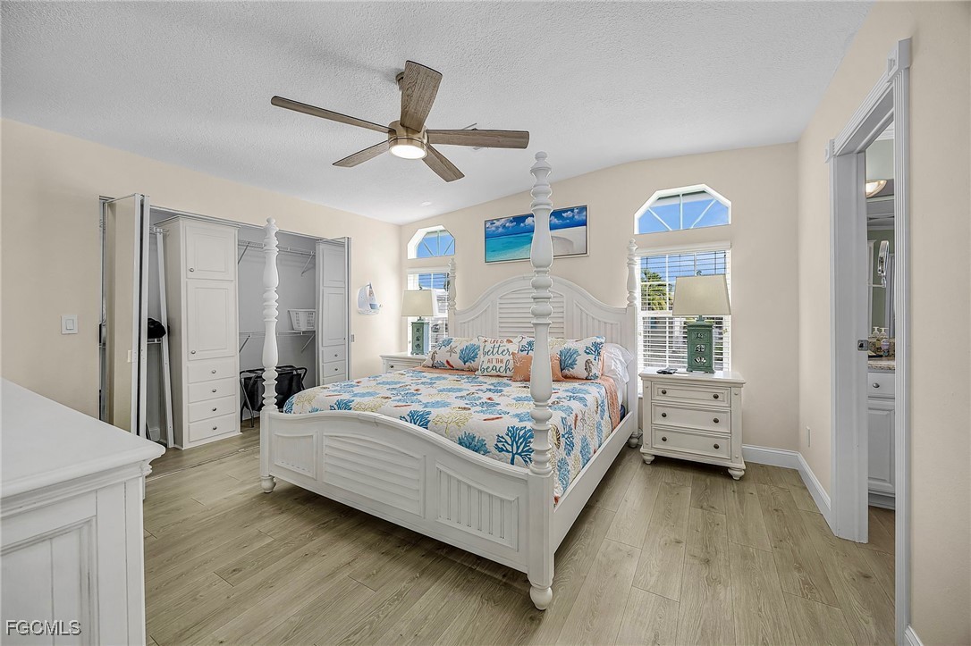 2991 Sloop Lane St. James City, FL 33956 - Photo 36 of 43 a bedroom with a bed and a chandelier