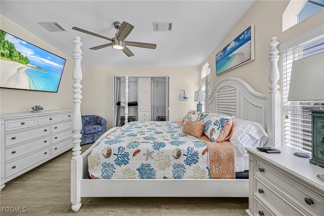 2991 Sloop Lane St. James City, FL 33956 - Photo 37 of 43 a bedroom with a bed a window and dresser