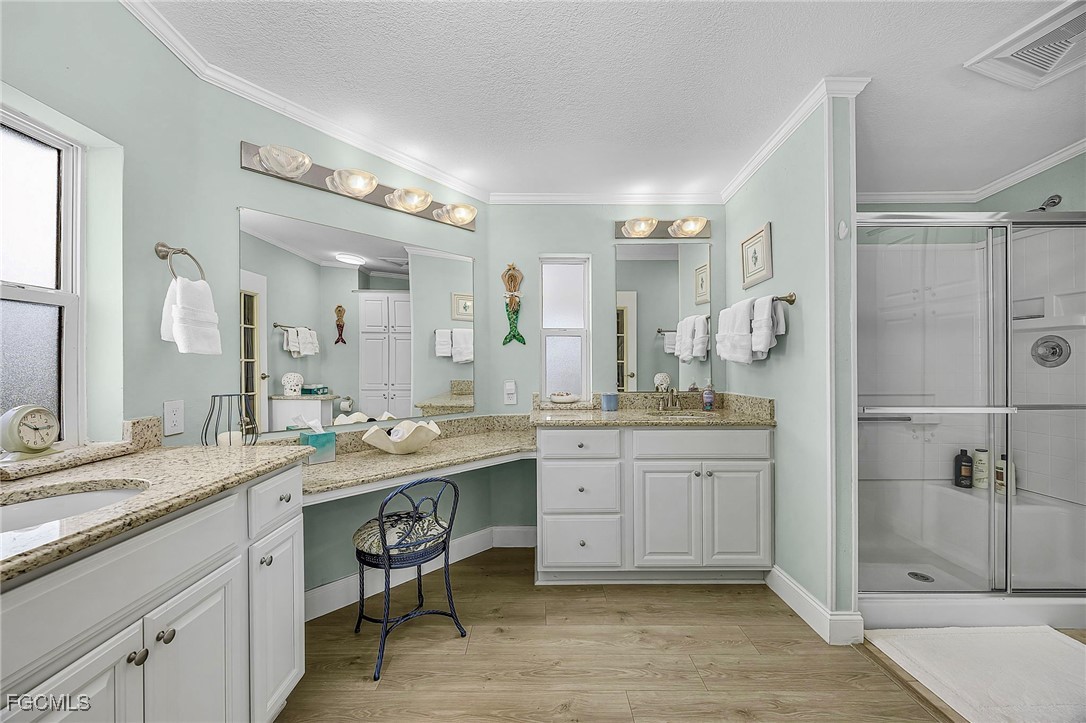 2991 Sloop Lane St. James City, FL 33956 - Photo 39 of 43 a spacious bathroom with a granite countertop sink mirror and a