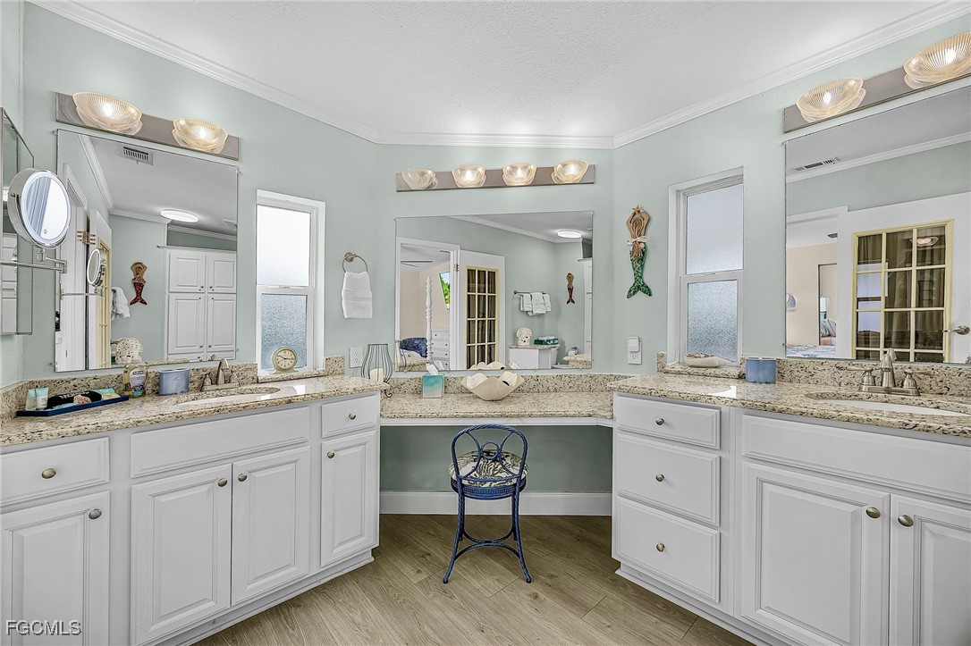 2991 Sloop Lane St. James City, FL 33956 - Photo 40 of 43 a spacious bathroom with a granite countertop sink and a mirror