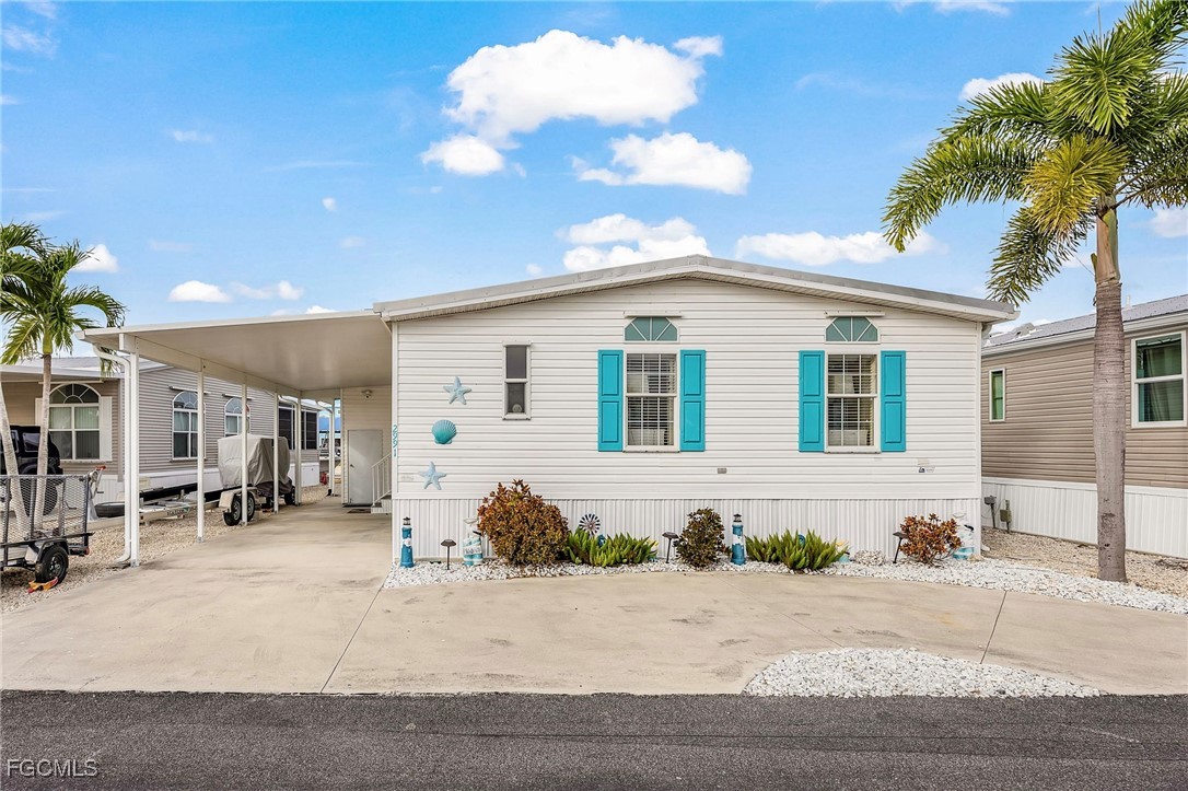 2991 Sloop Lane St. James City, FL 33956 - Photo 4 of 43 a front view of a house with a yard