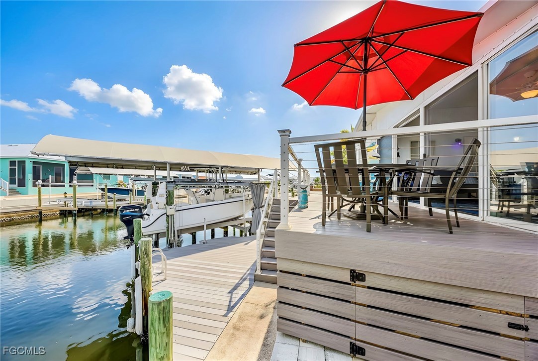 2991 Sloop Lane St. James City, FL 33956 - Photo 5 of 43 a view of a swimming pool with a table and chairs
