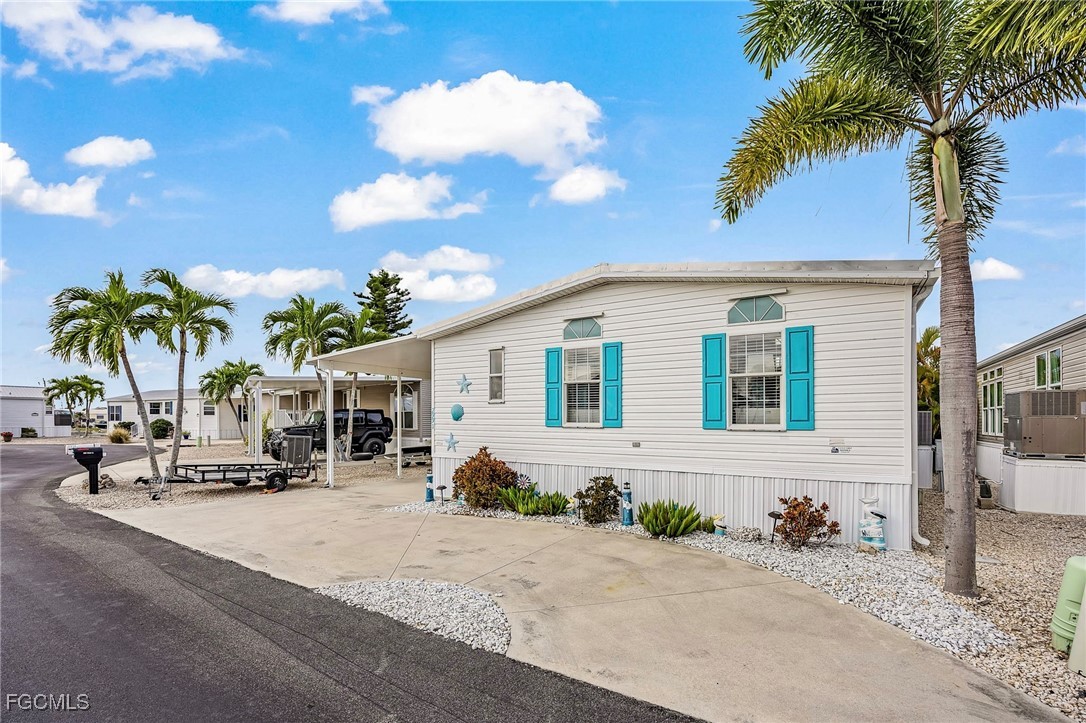 2991 Sloop Lane St. James City, FL 33956 - Photo 7 of 43 a group of palm trees in front of a house