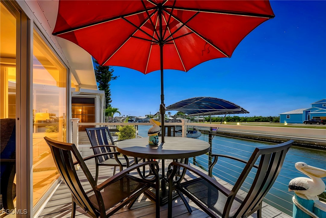 2991 Sloop Lane St. James City, FL 33956 - Photo 8 of 43 a view of an outdoor space with furniture and umbrella
