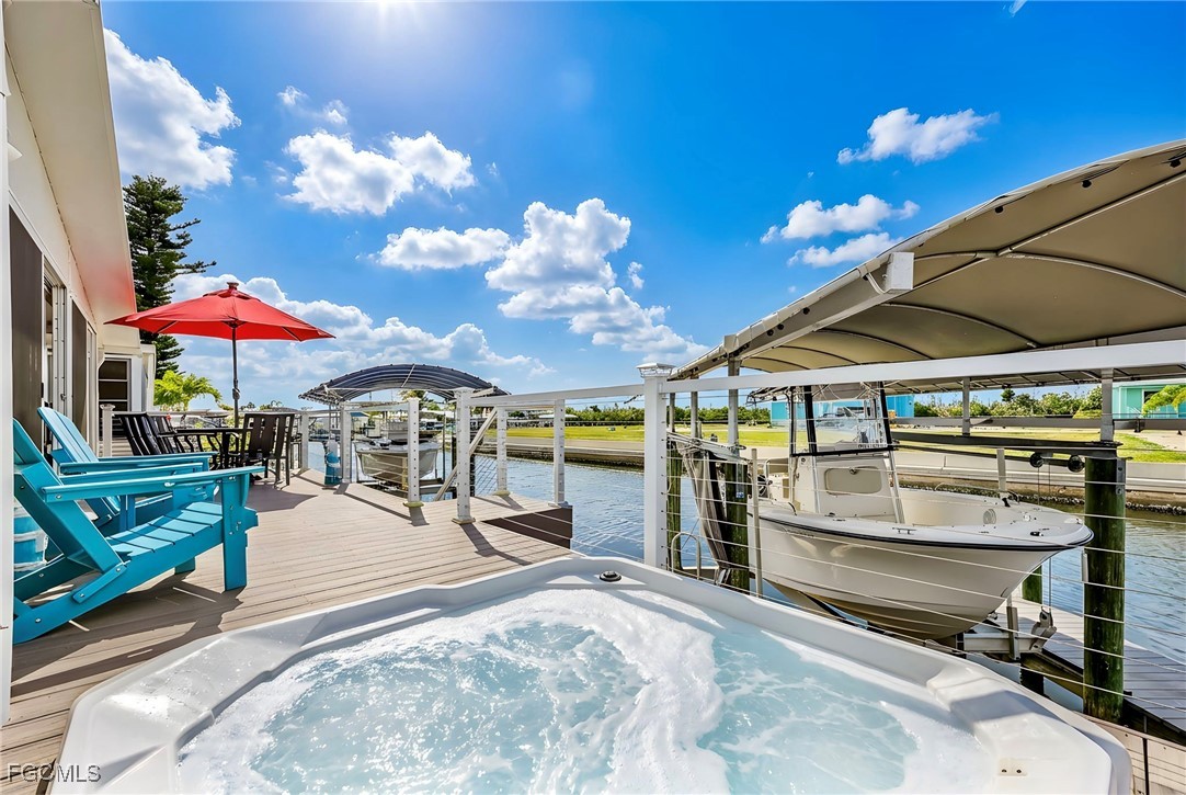 2991 Sloop Lane St. James City, FL 33956 - Photo 10 of 43 a view of a patio with a table and chairs under an umbrella