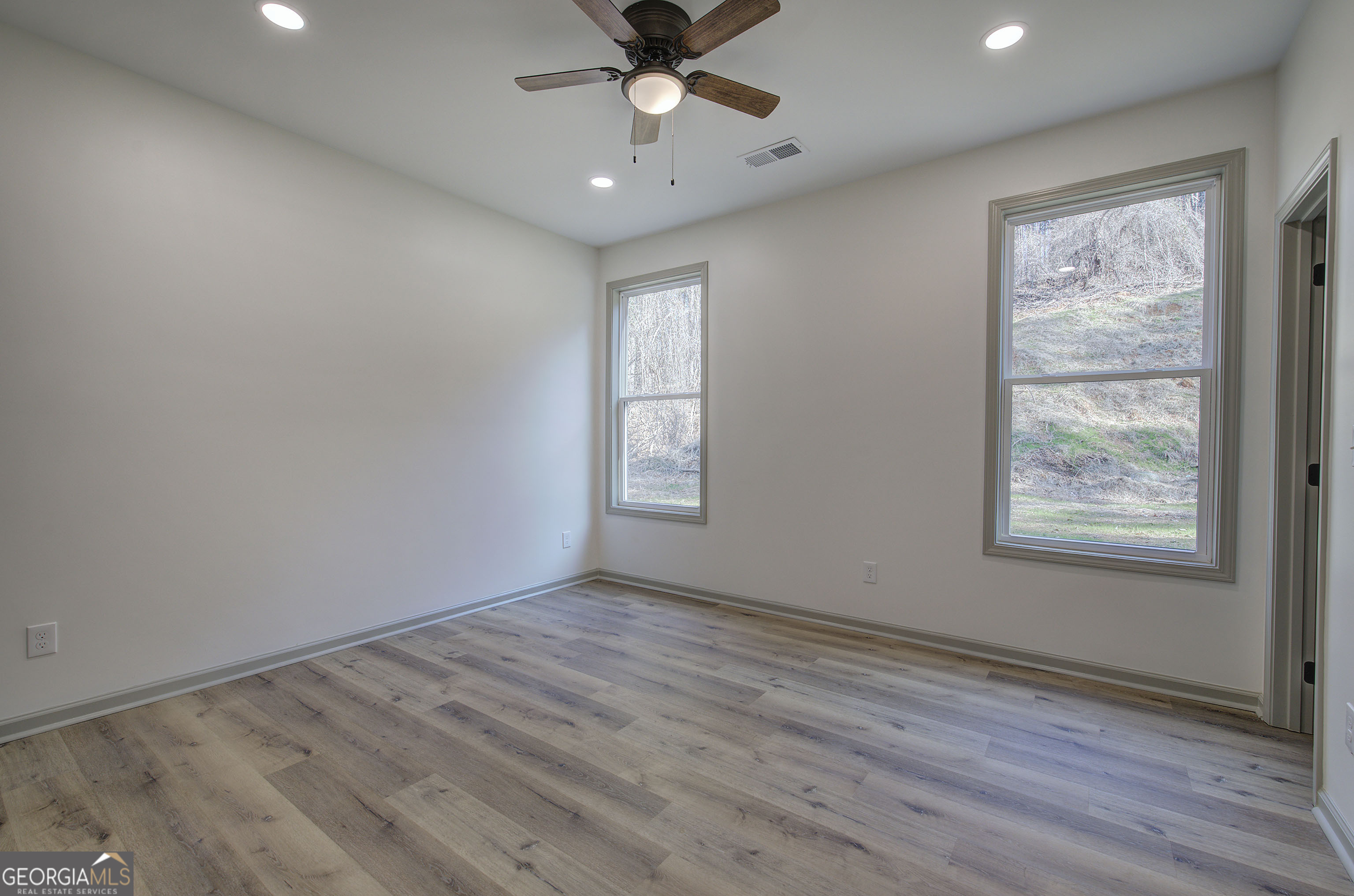 115 East Boundary Rome, GA 30161 - Photo 21 of 34 an empty room with wooden floor chandelier fan and windows