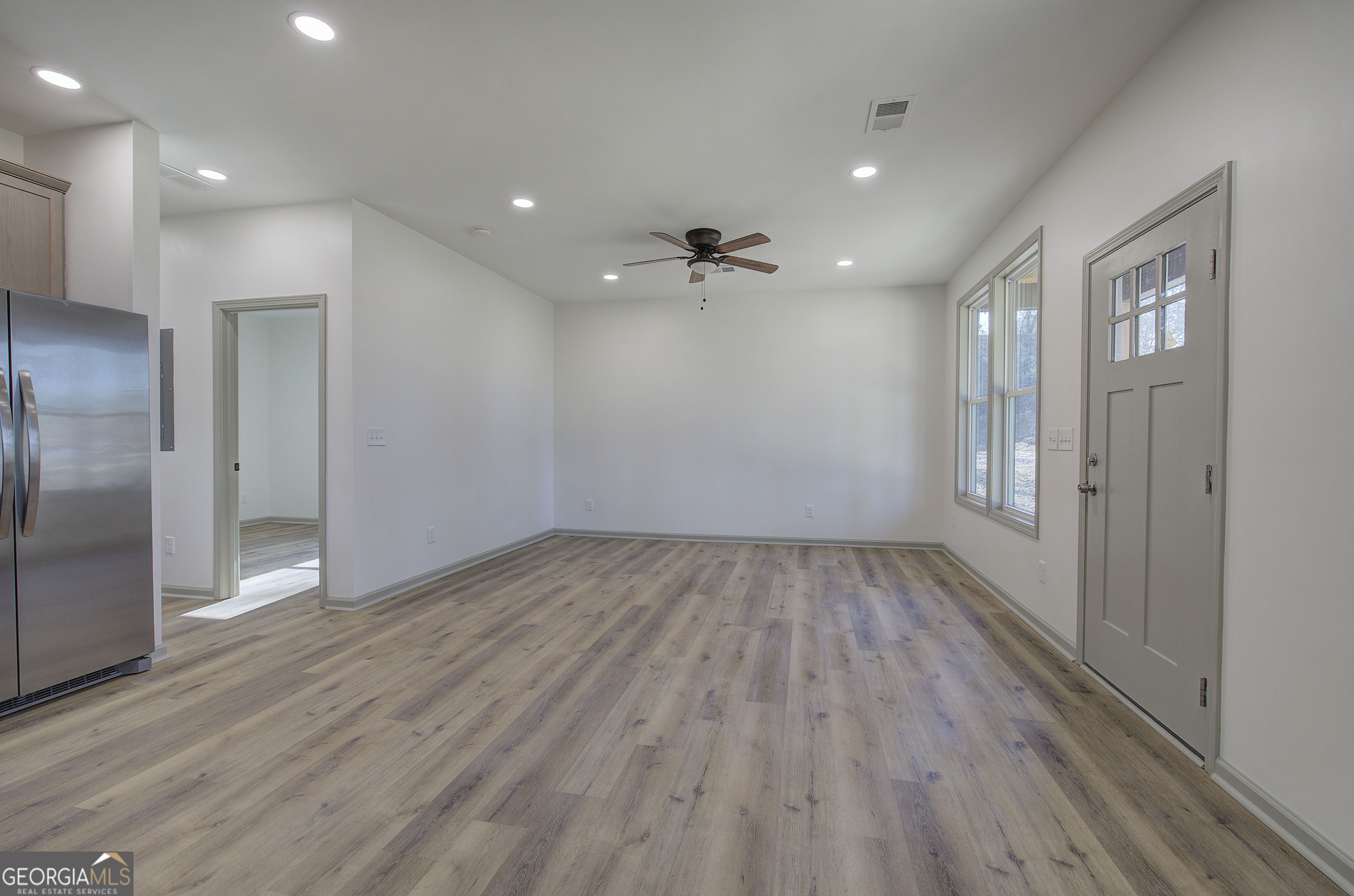 115 East Boundary Rome, GA 30161 - Photo 8 of 34 an empty room with wooden floor and a hallway