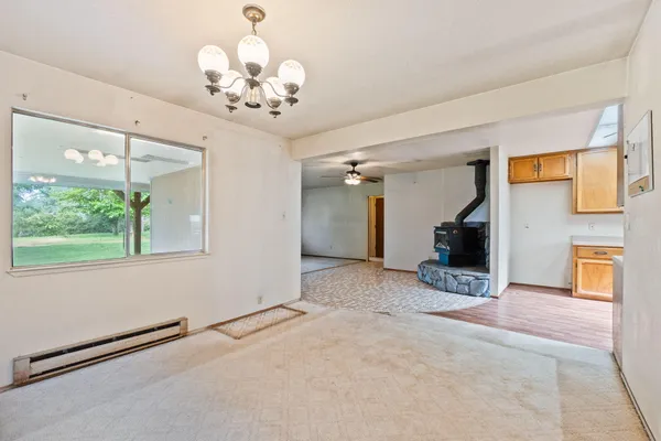 a view of a livingroom with a ceiling fan a ceiling fan and windows