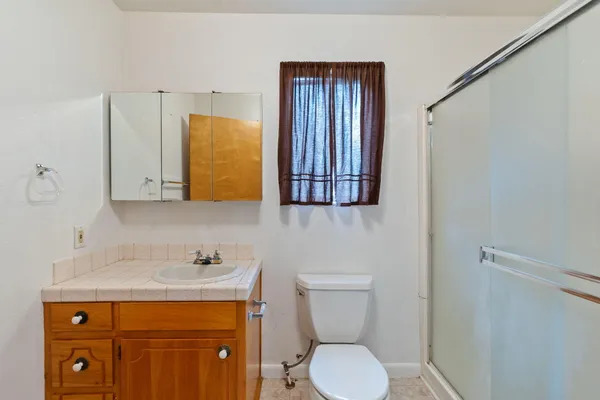 a bathroom with a sink a toilet and a mirror