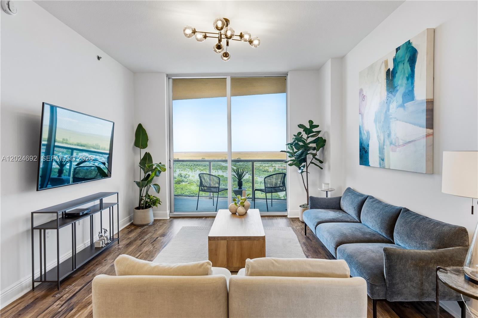 2641 North Flamingo Road, Unit 2605N Sunrise, FL 33323 - Photo 6 of 56 a living room with furniture a window and a flat screen tv