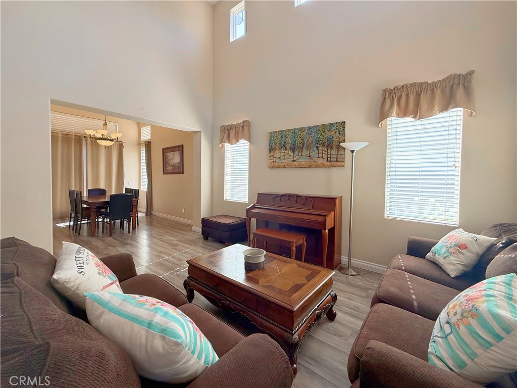 23964 Old Pomegranate Road Yorba Linda, CA 92887 - Photo 13 of 30 a living room with furniture a ceiling fan and a window
