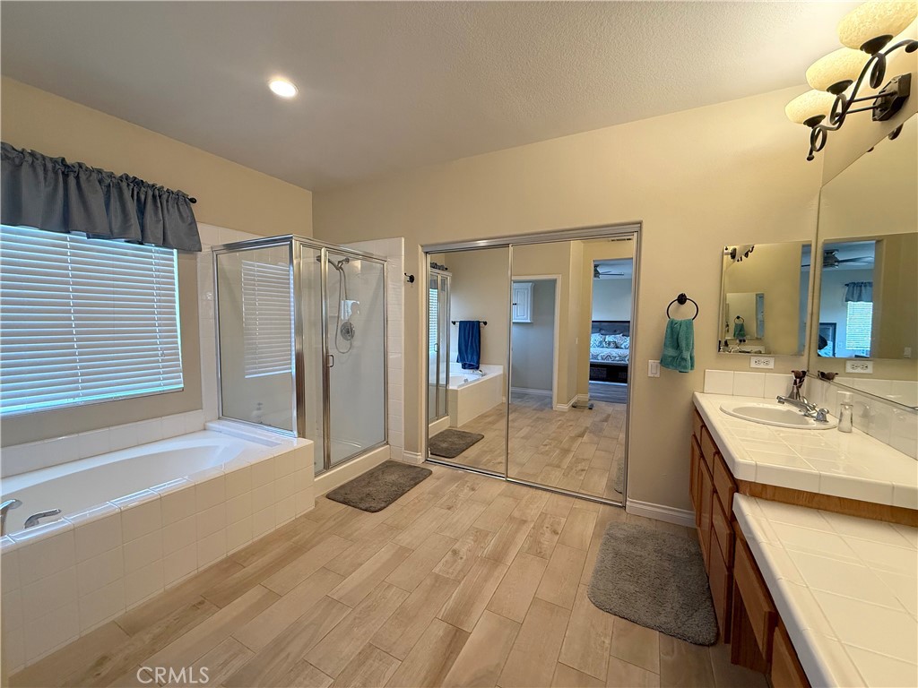 23964 Old Pomegranate Road Yorba Linda, CA 92887 - Photo 23 of 30 a spacious bathroom with a granite countertop sink a mirror and shower