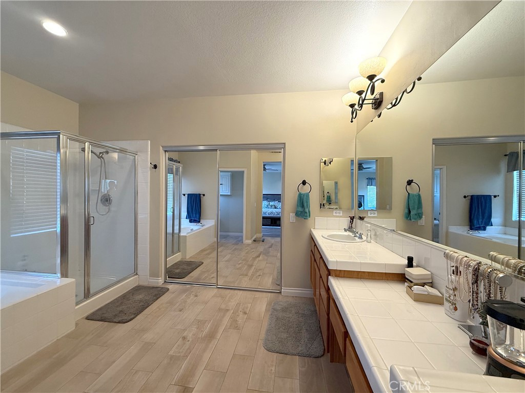 23964 Old Pomegranate Road Yorba Linda, CA 92887 - Photo 24 of 30 a large bathroom with a double vanity sink a large mirror and shower
