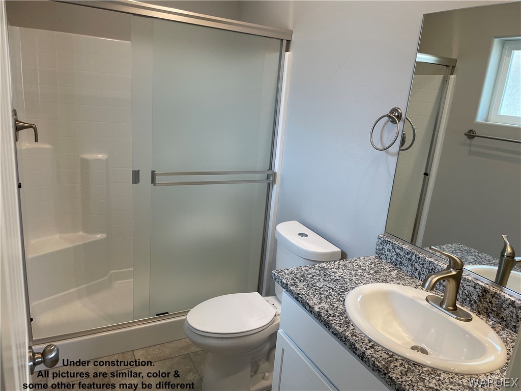 3555 North Kenneth Road Kingman, AZ 86409 - Photo 14 of 19 a bathroom with a granite countertop sink toilet and shower