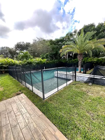 a view of a garden with wooden fence