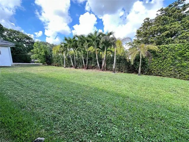 a view of grassy field with trees