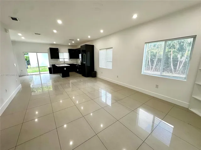 a view of a kitchen with furniture and a window