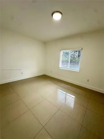 an empty room with a empty space and a window