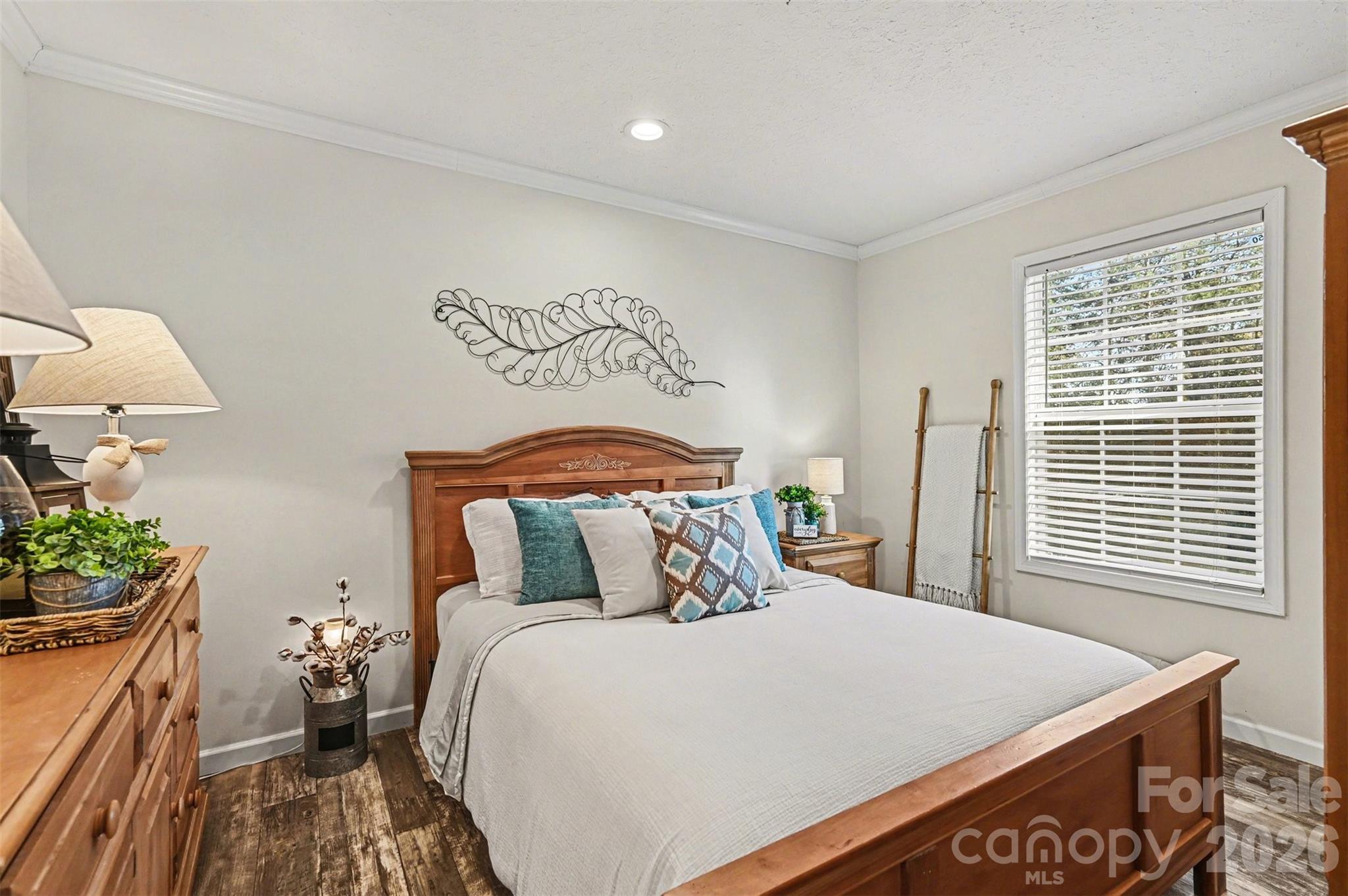 420 Hoffman Road Lincolnton, NC 28092 - Photo 12 of 25 a bedroom with a bed and a potted plant