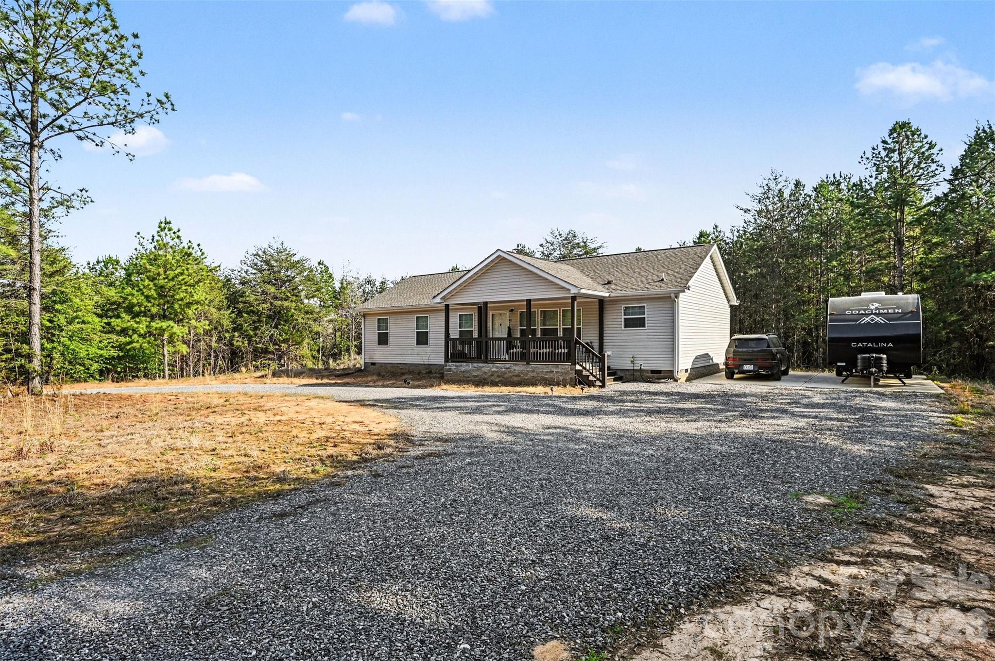 420 Hoffman Road Lincolnton, NC 28092 - Photo 3 of 25 a front view of a house with a yard and a garage